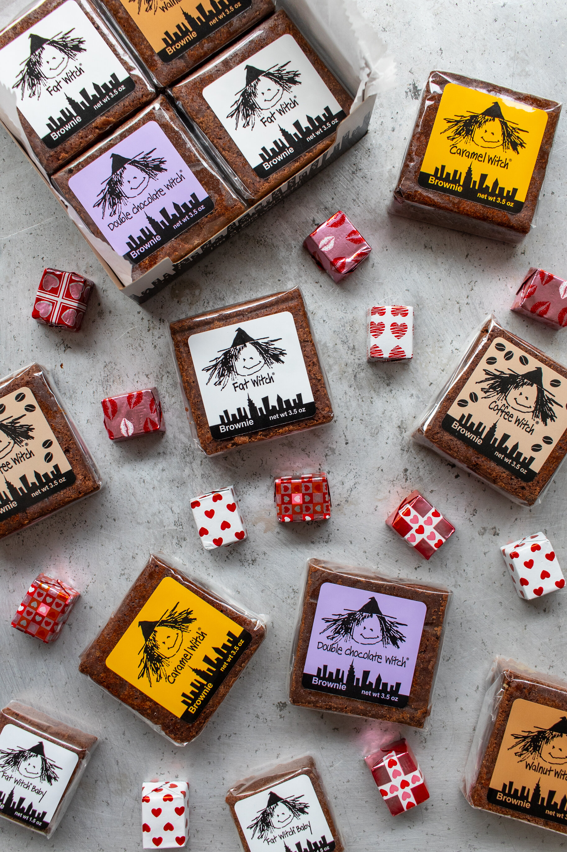 different wrapped brownies with pink red and white chocolates scattered