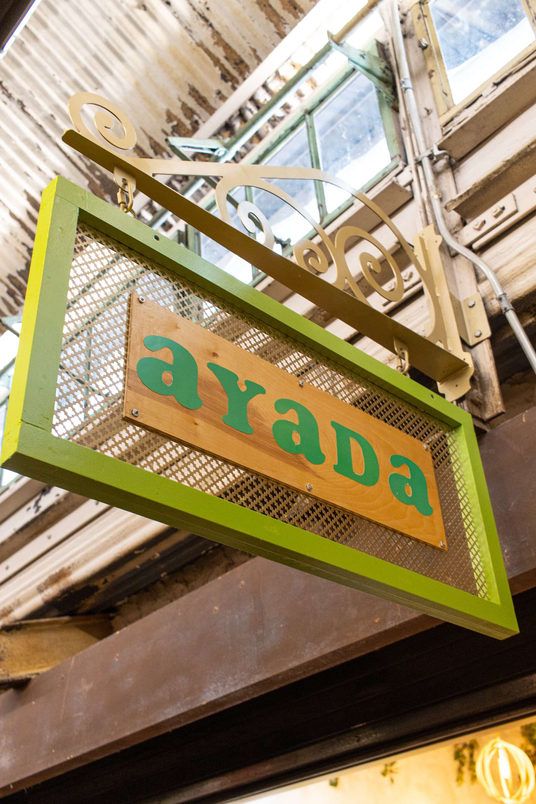 hanging wood sign reading "ayada"