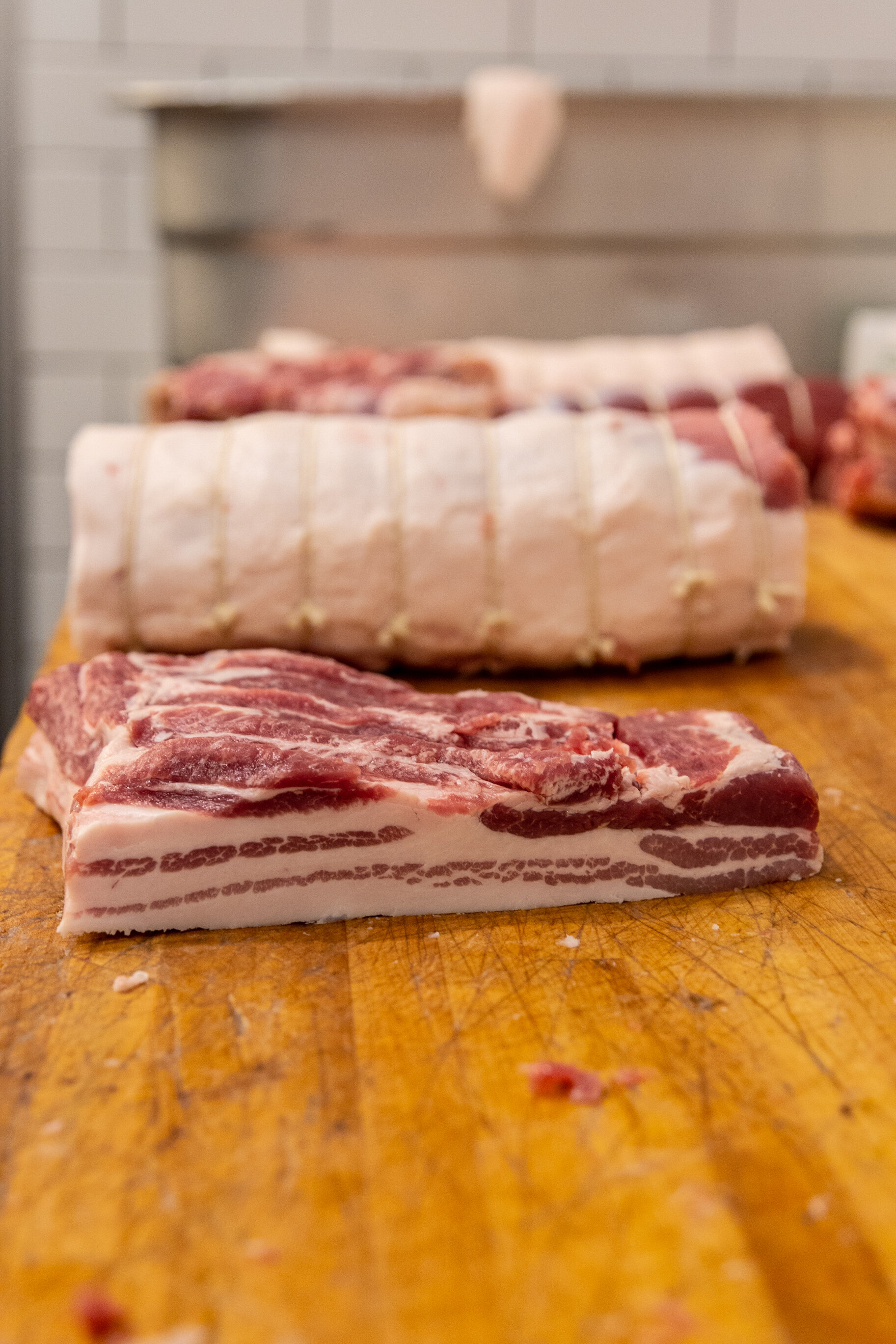 different cuts of meat on a wood board