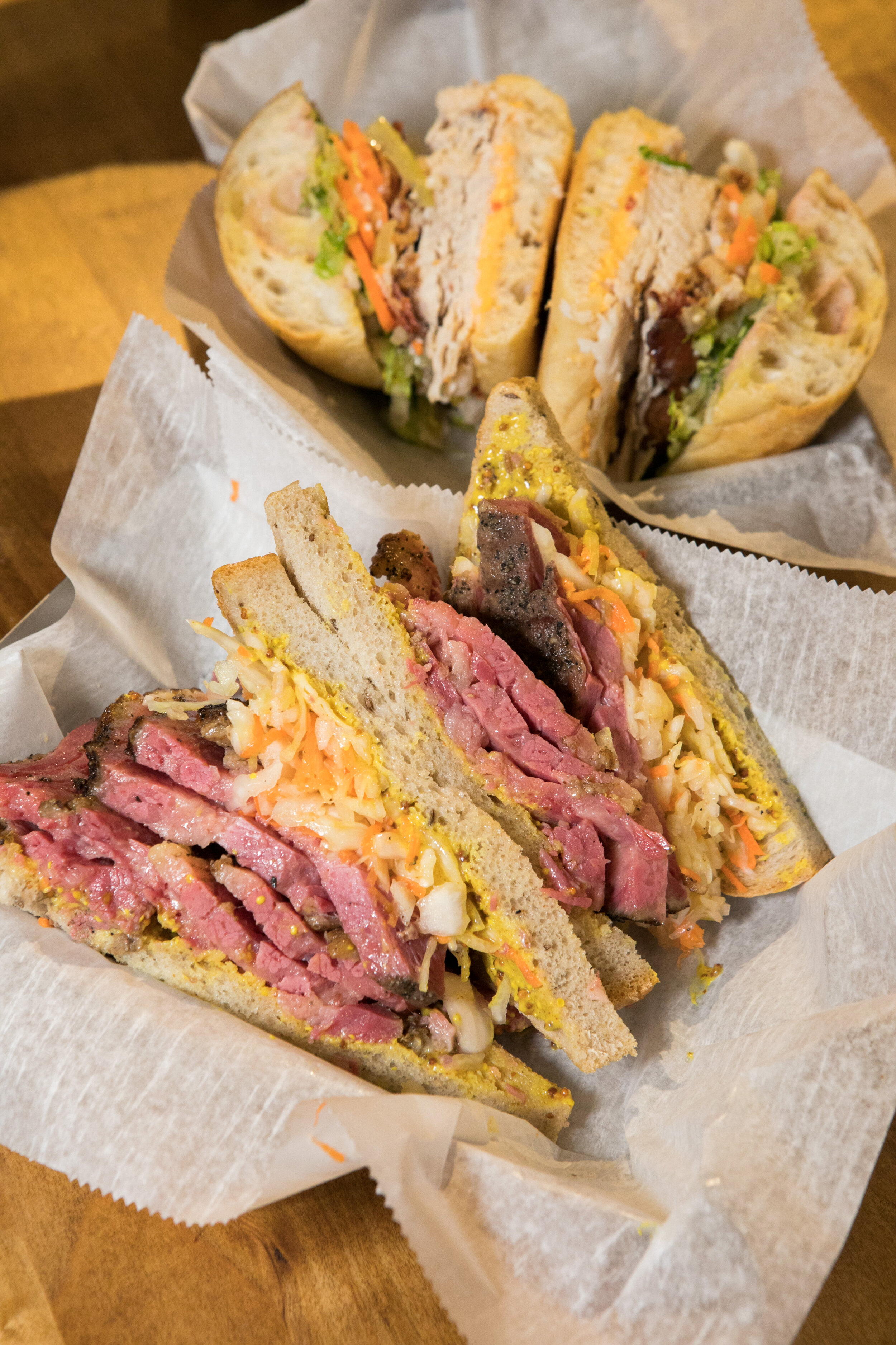 two different sandwiches in lunch baskets 