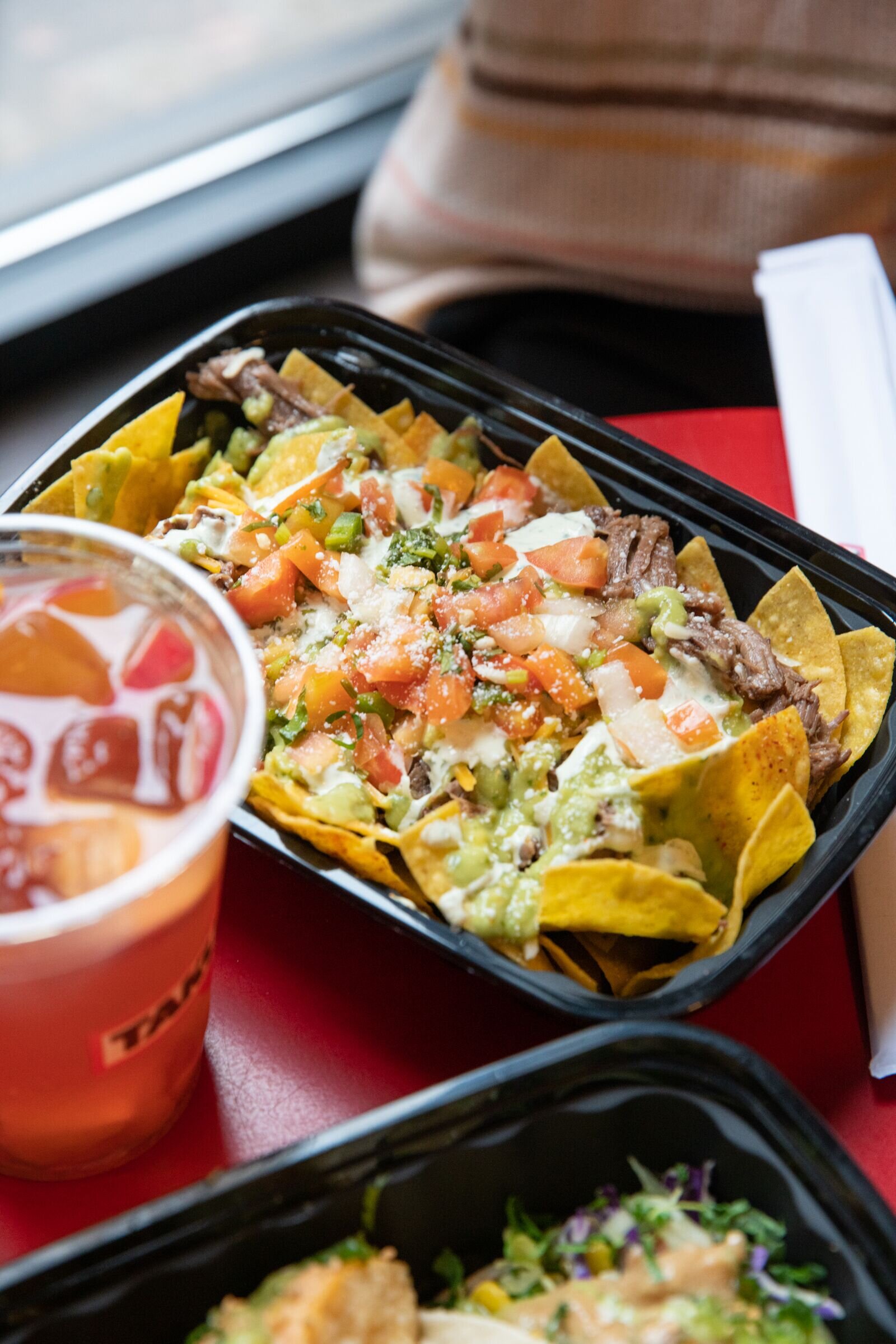 takumi nachos with a drink 