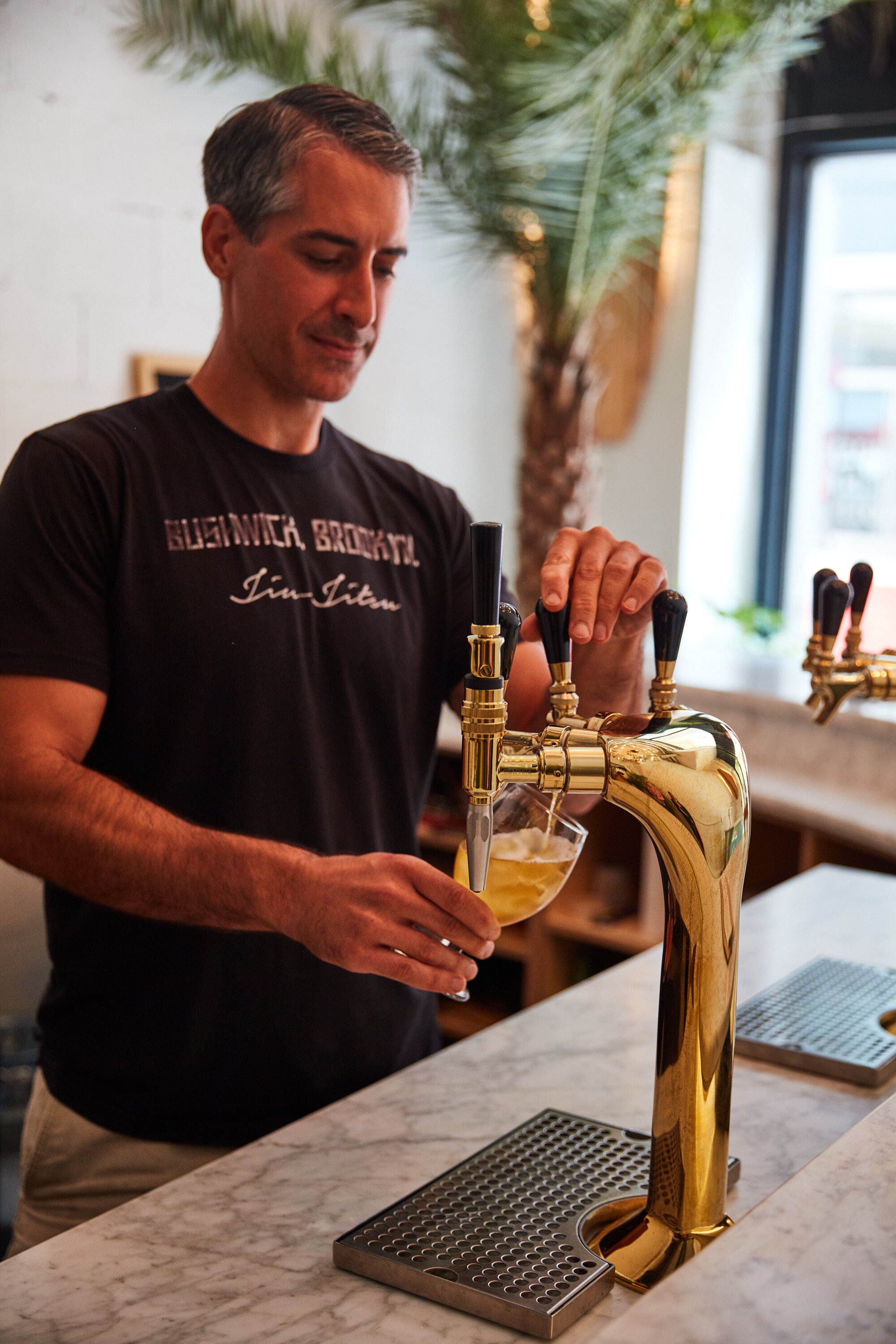  Man pours drink from bar spout 