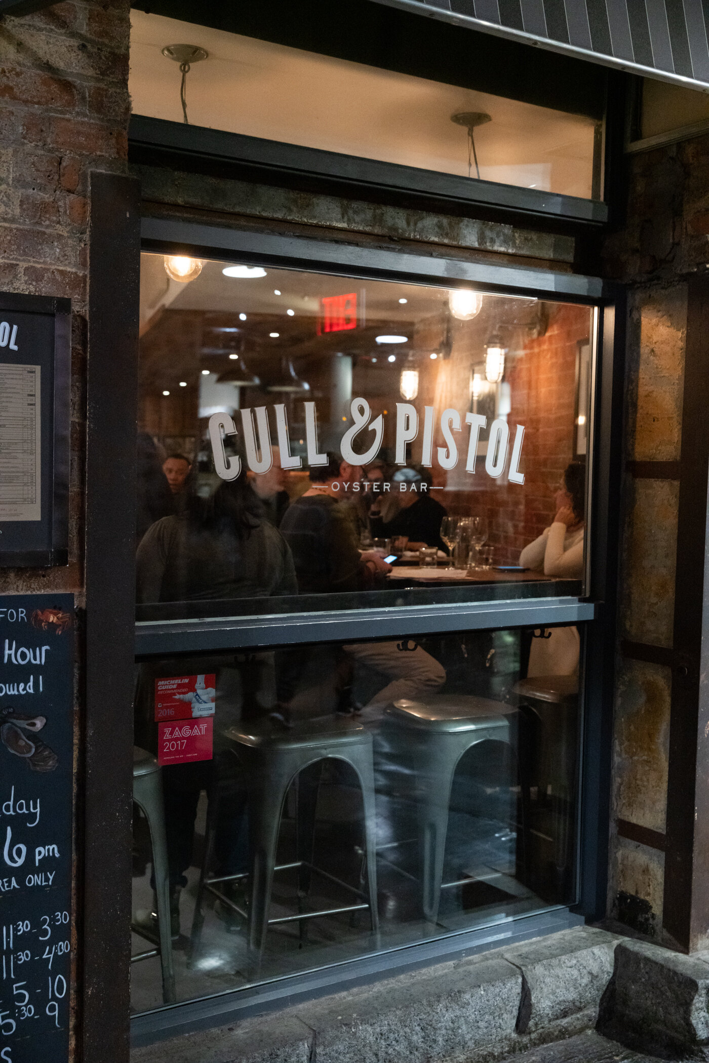 exterior steel window with signage reading Cull and Pistol