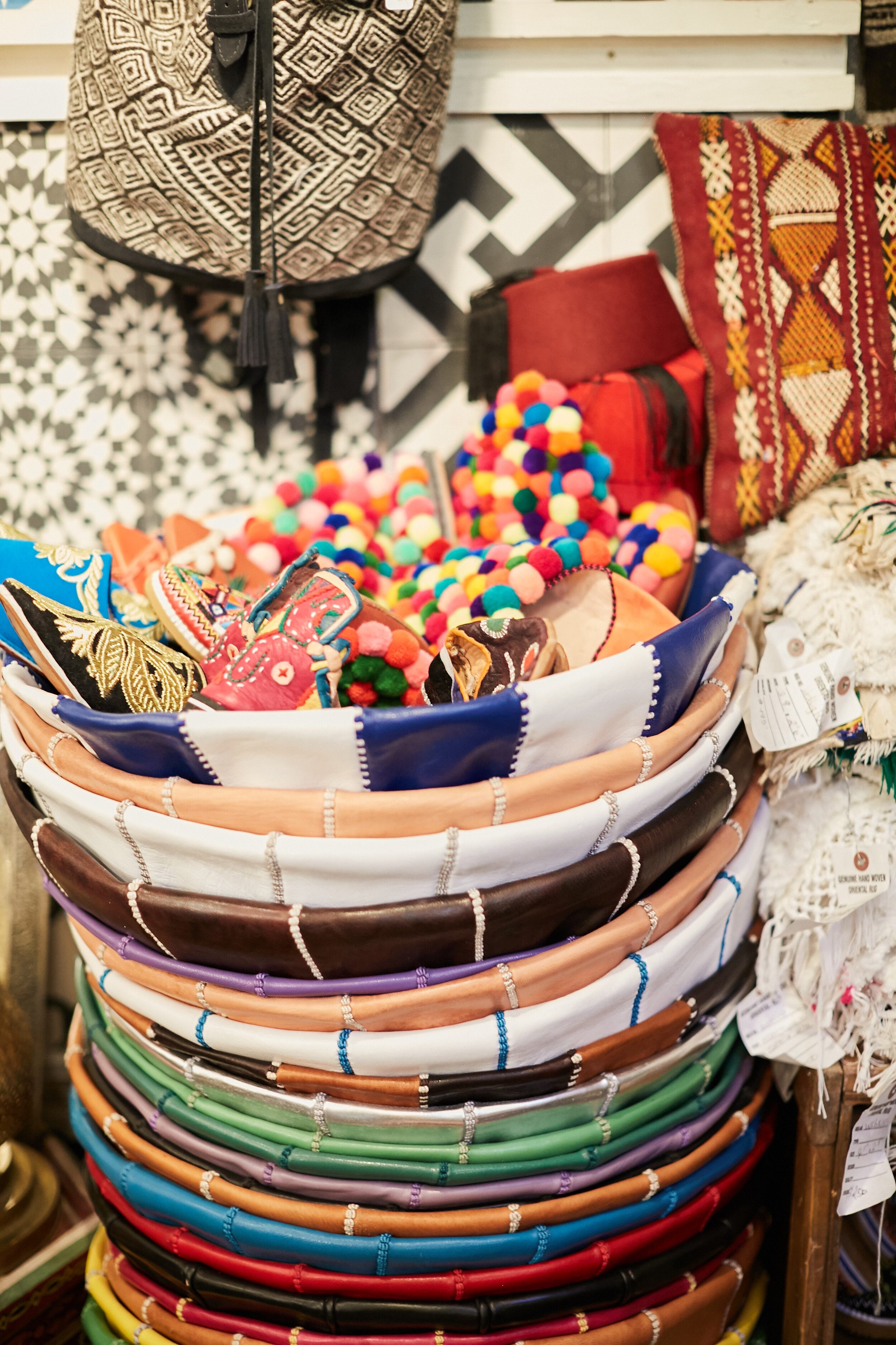 shoes resting in large leather bowls stacked 