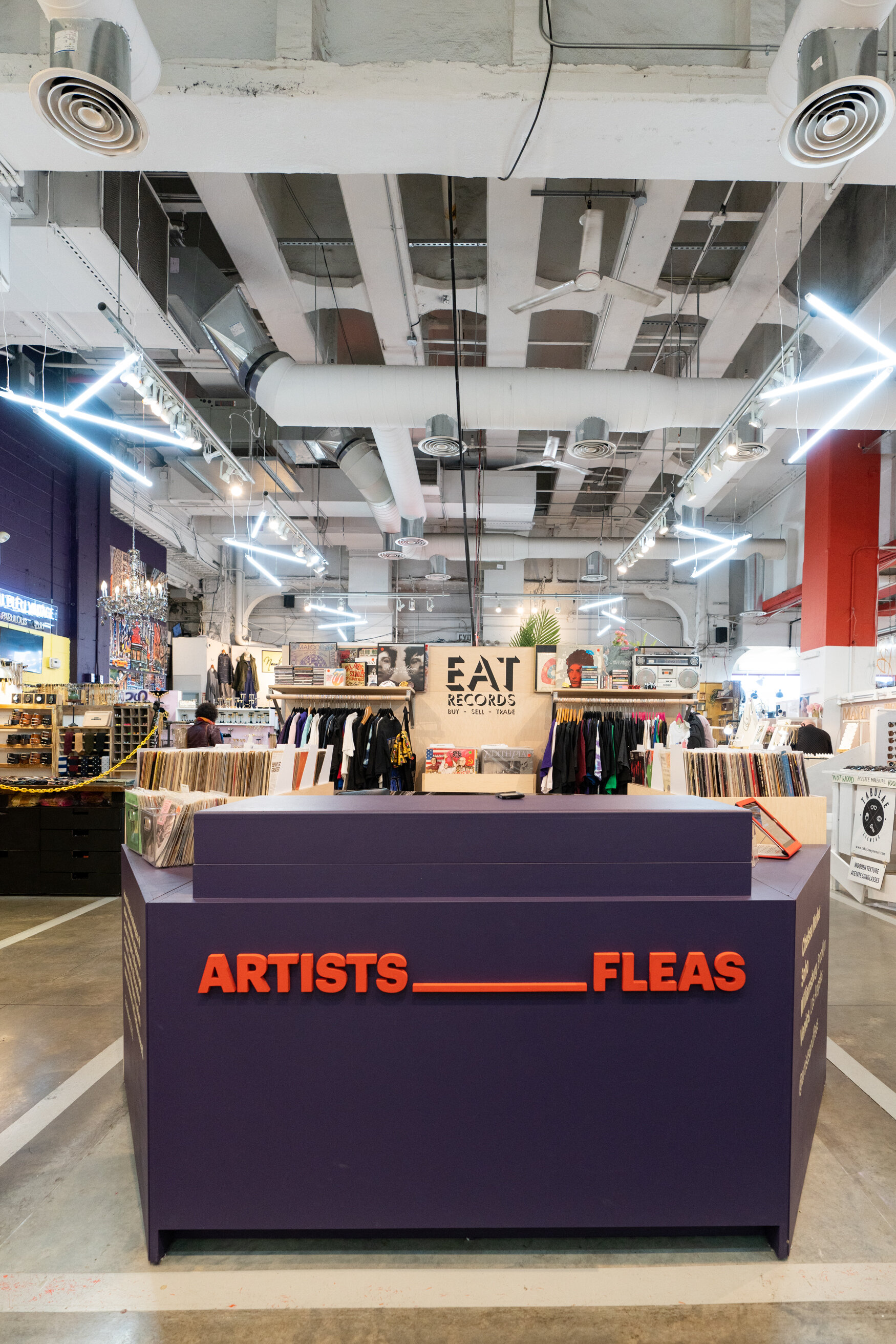 booth inside space reading artist and fleas on front