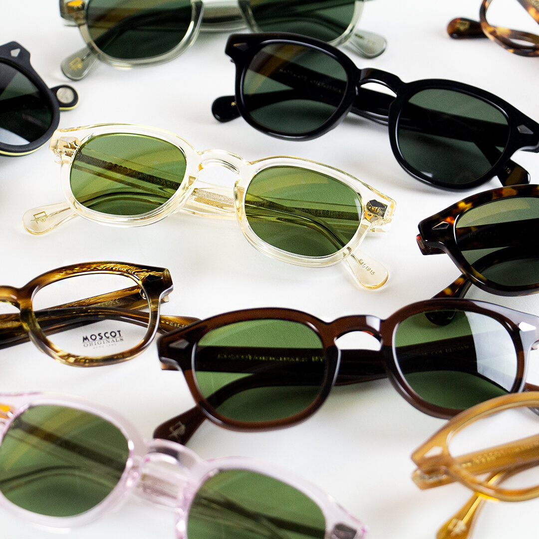 sunglasses and reading glasses on a white table top 