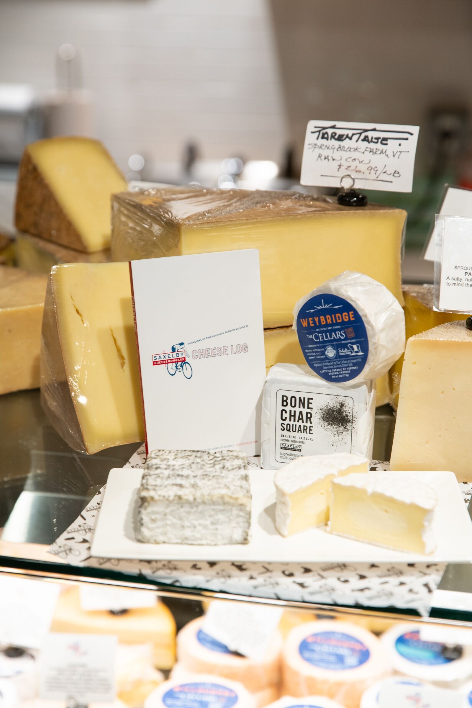 close up of two different types of cheeses on a plate