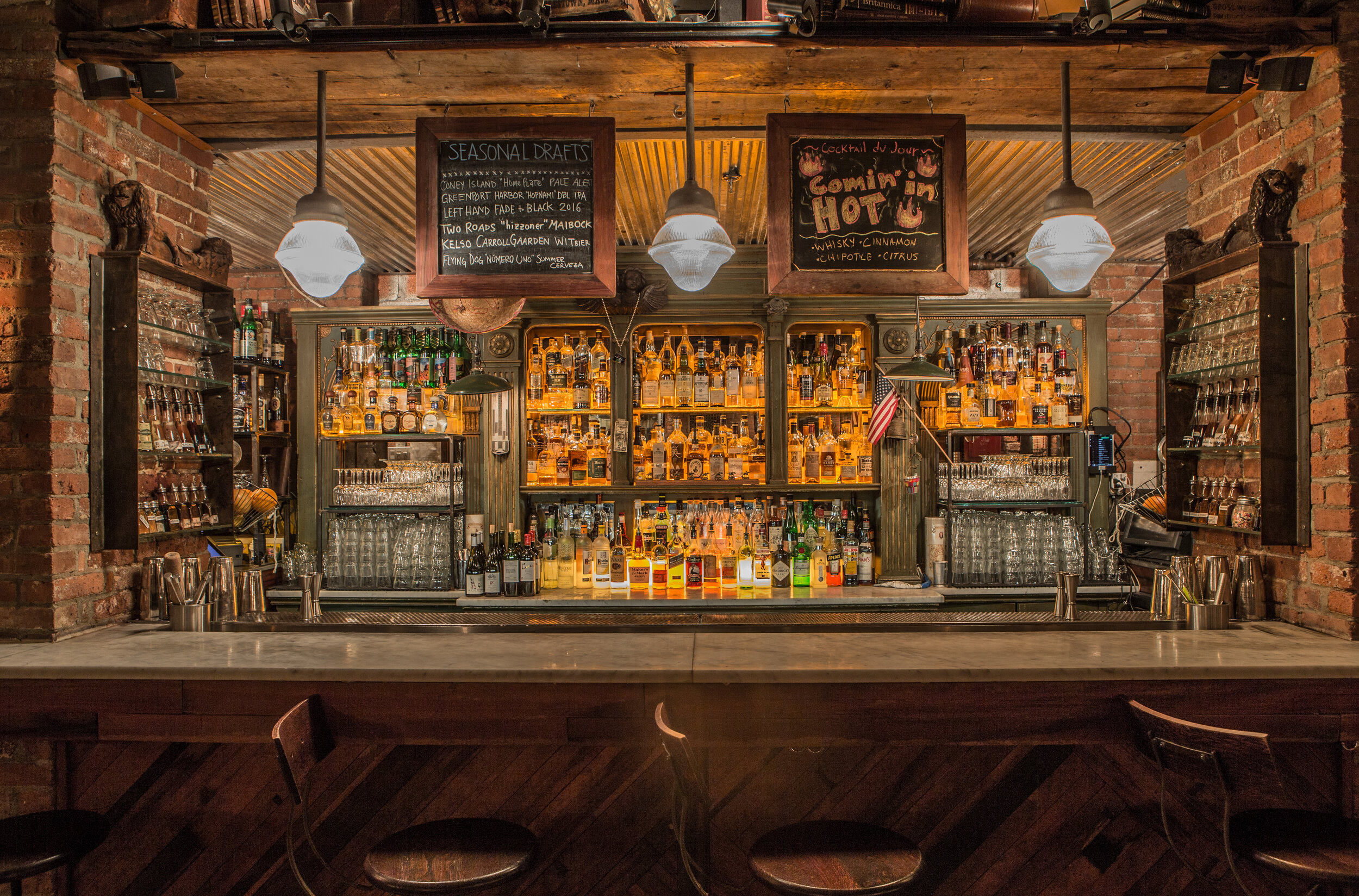 the tippler bar, empty of people, filled with many different bottles 